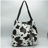Cow print shoulder bag with tassel - black